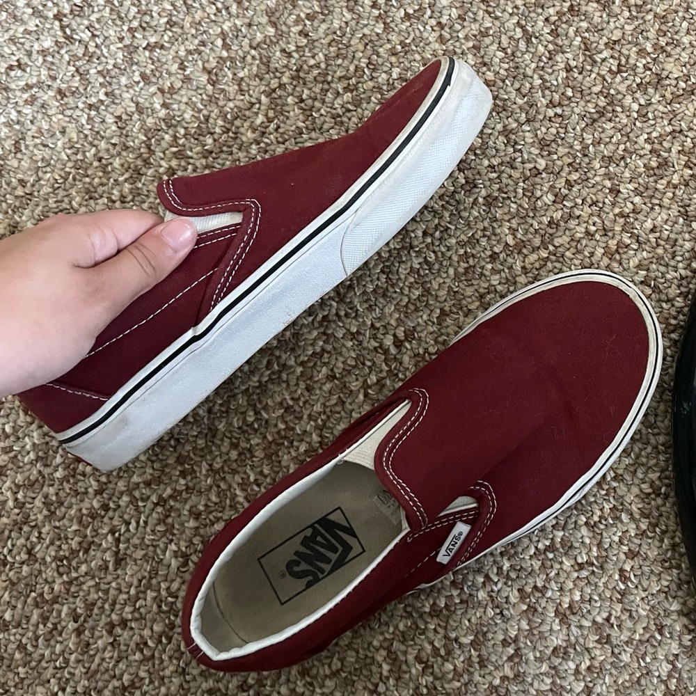 Maroon colored slip on vans